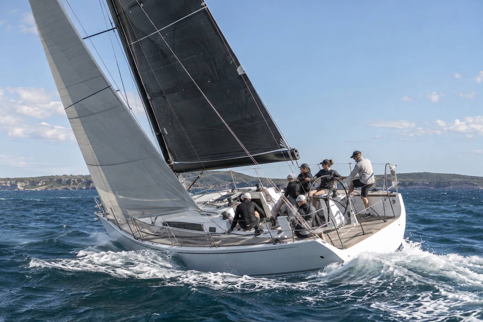 Racing yacht crew sailing in fresh coastal conditions